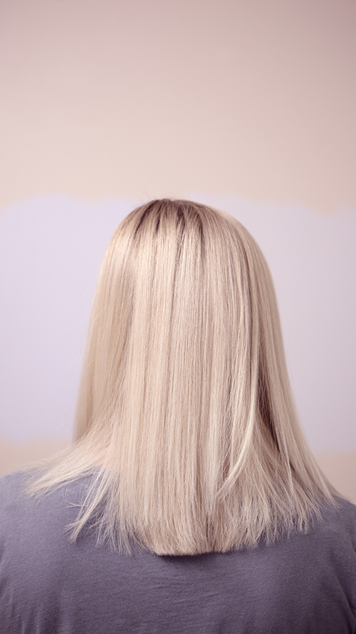 Woman with blonde straight hair to shoulders