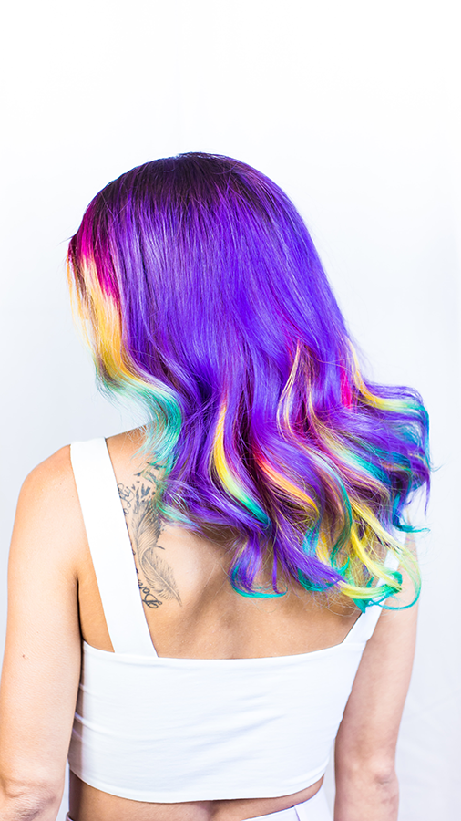 Woman with hair dyed with all the colors from the rainbow
