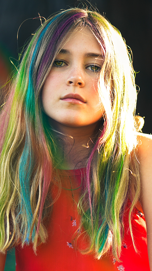 Girl with rainbow colored highlights